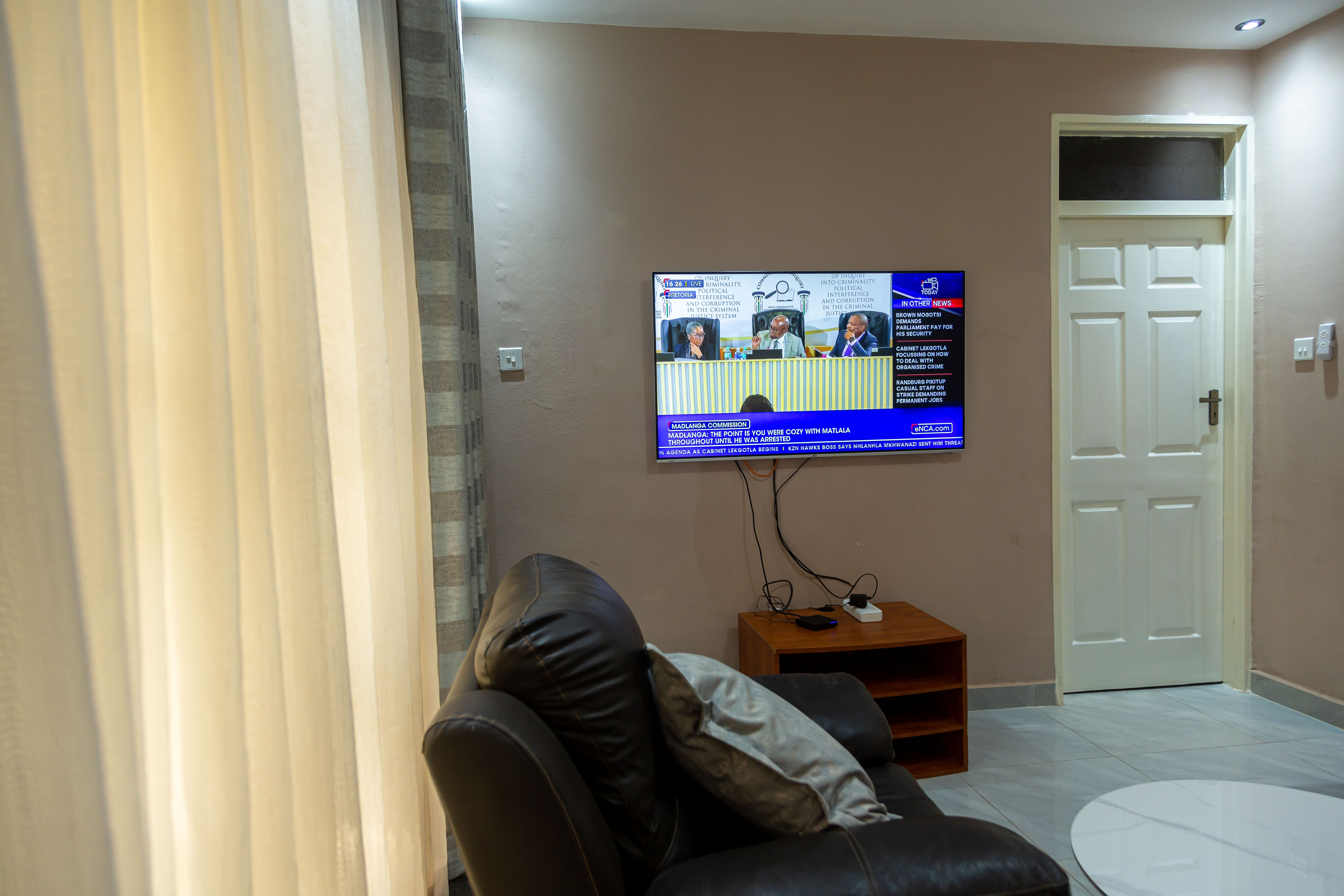 Living room television and sofa beside the doorway