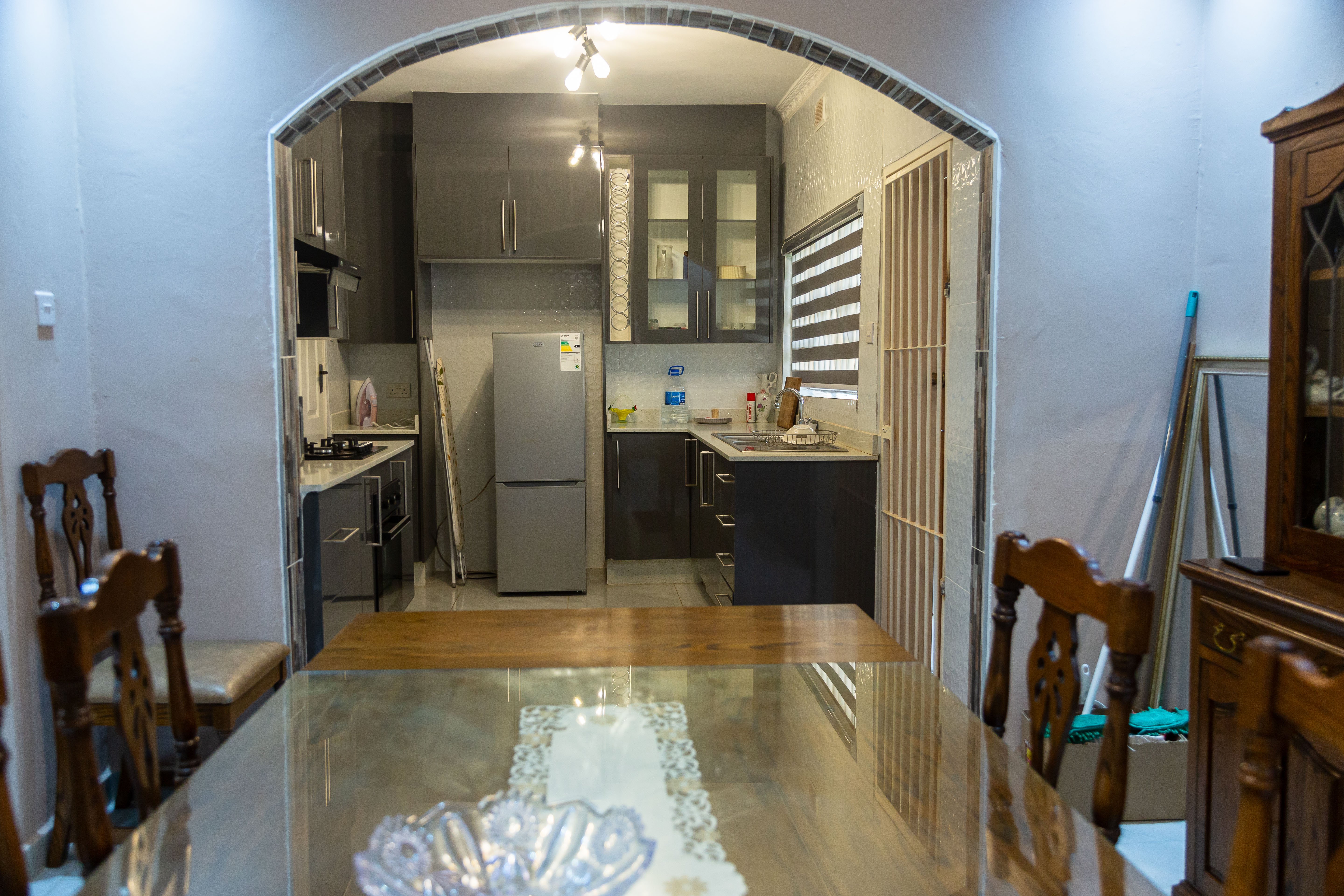 Dining table looking through an arch into the kitchen