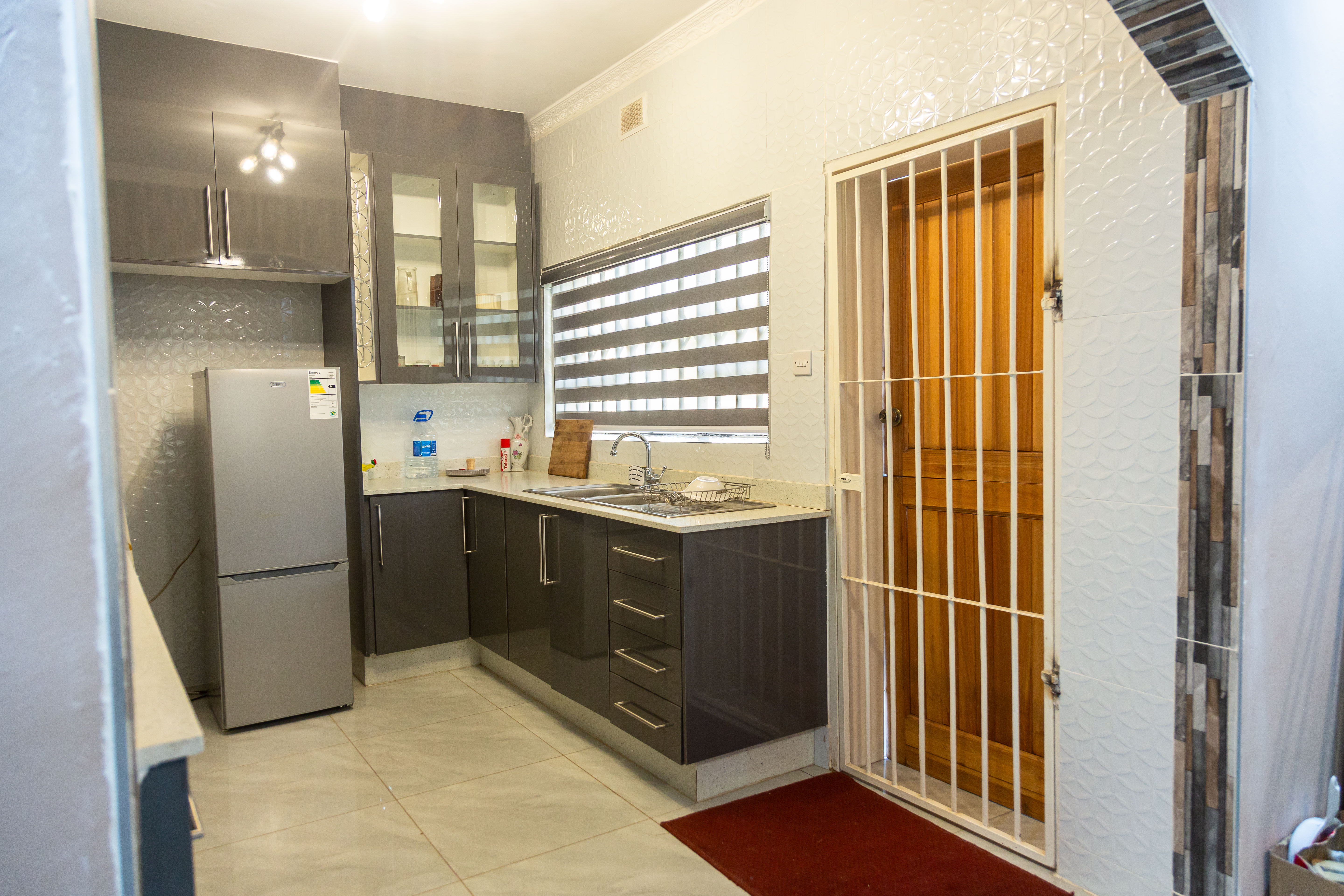 Kitchen sink, window, and security door