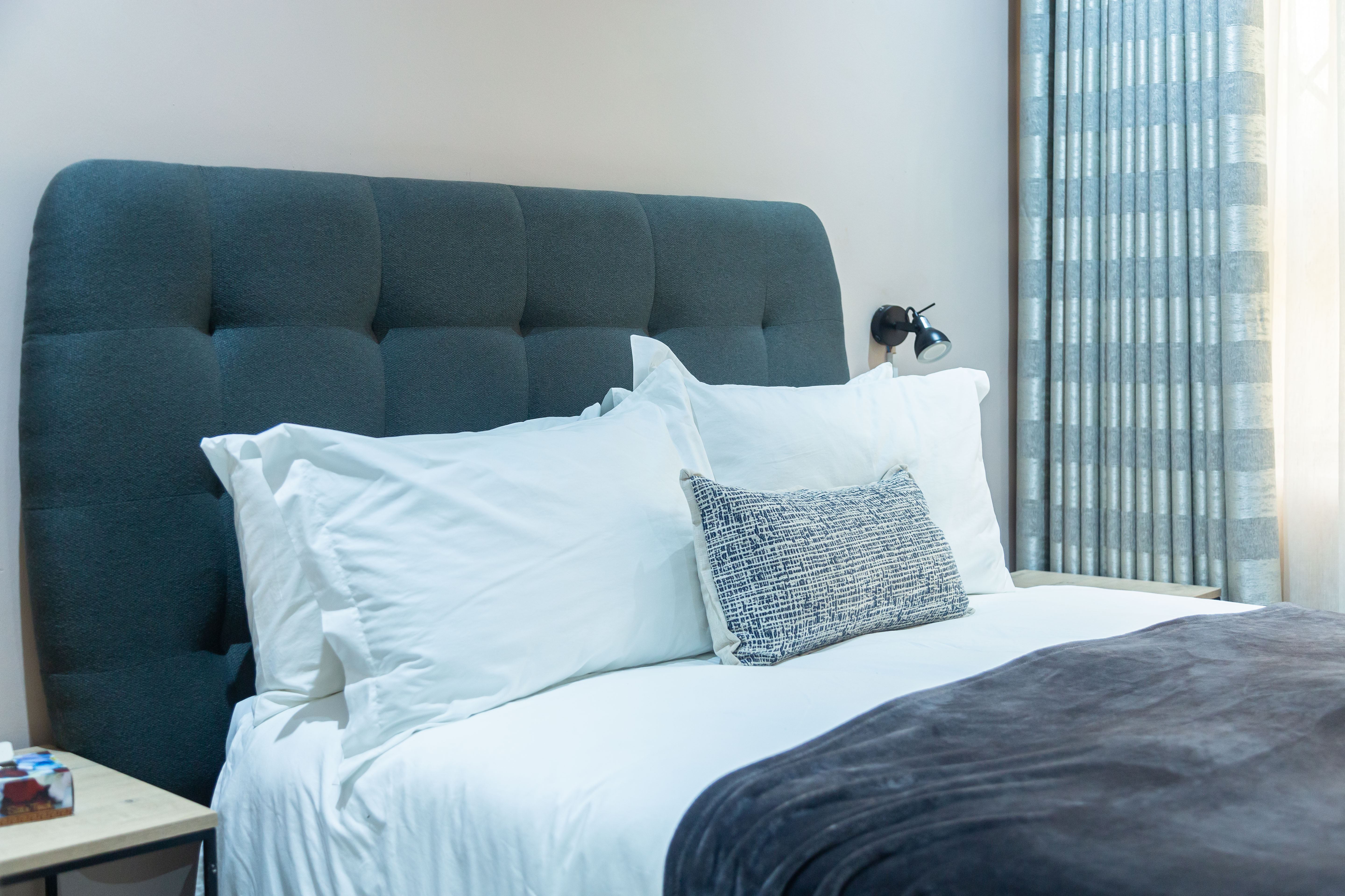 Close view of the bedroom pillows and headboard