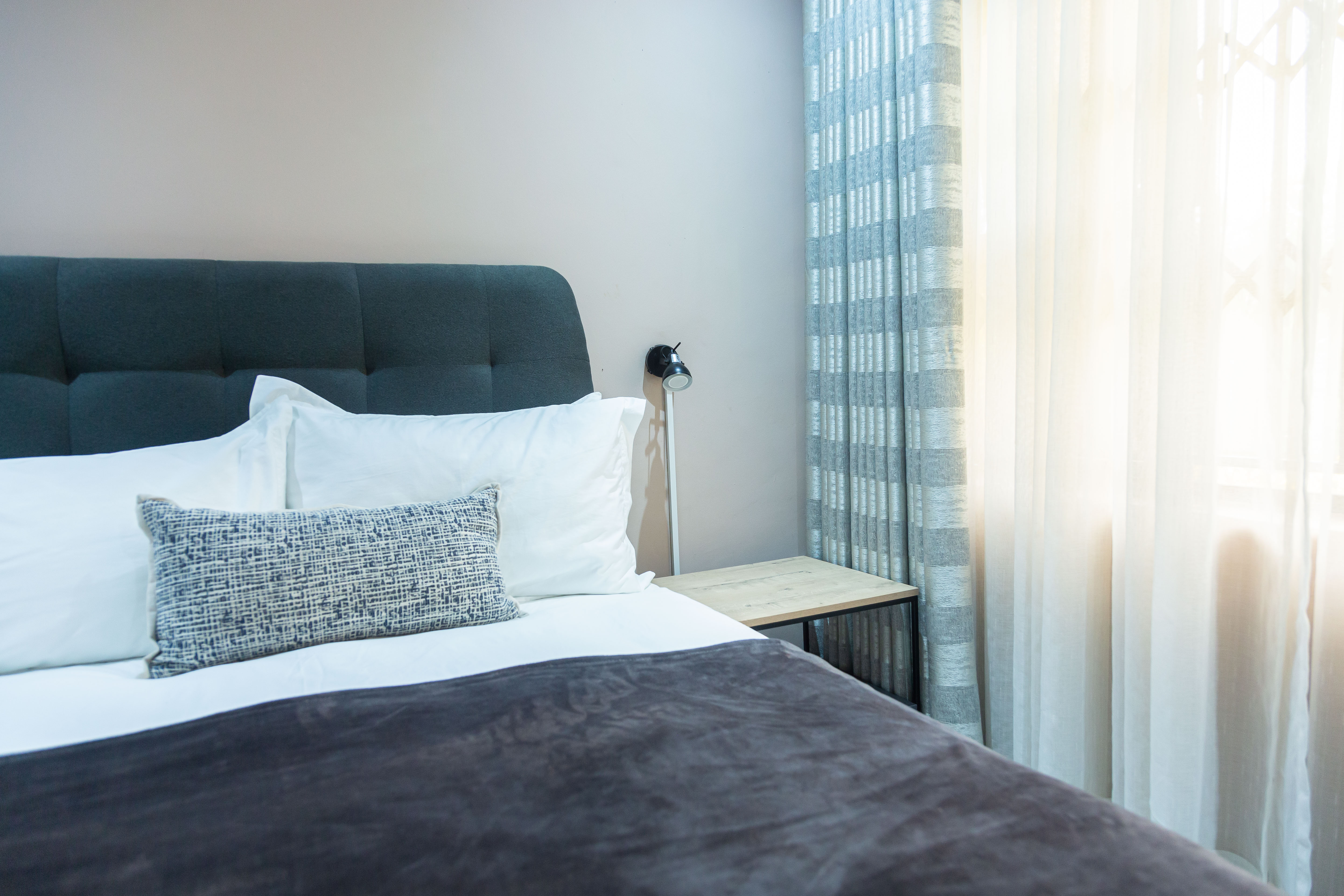 Bedside table and reading lamp beside the bed