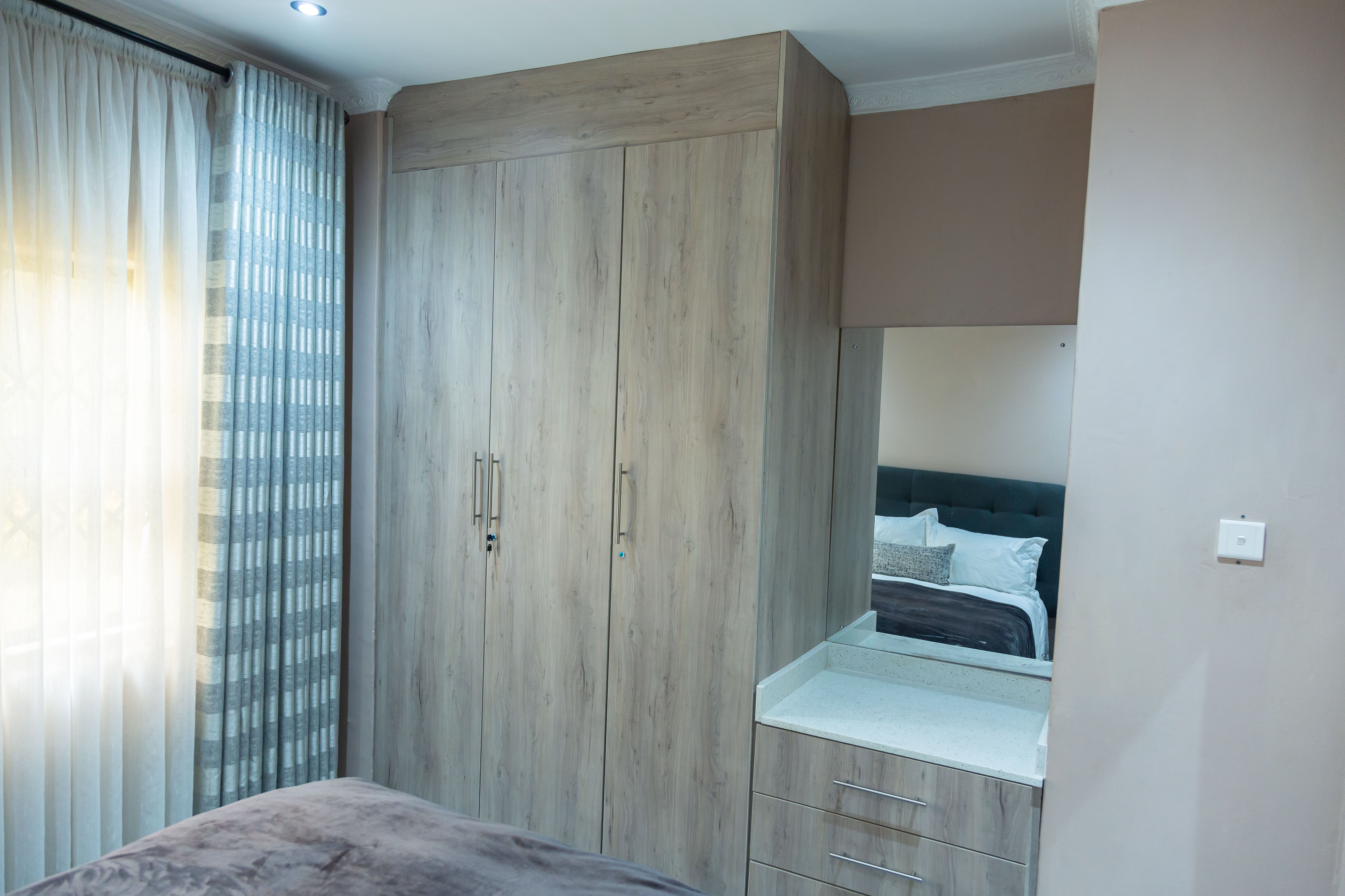 Bedroom wardrobe with a mirror and drawers