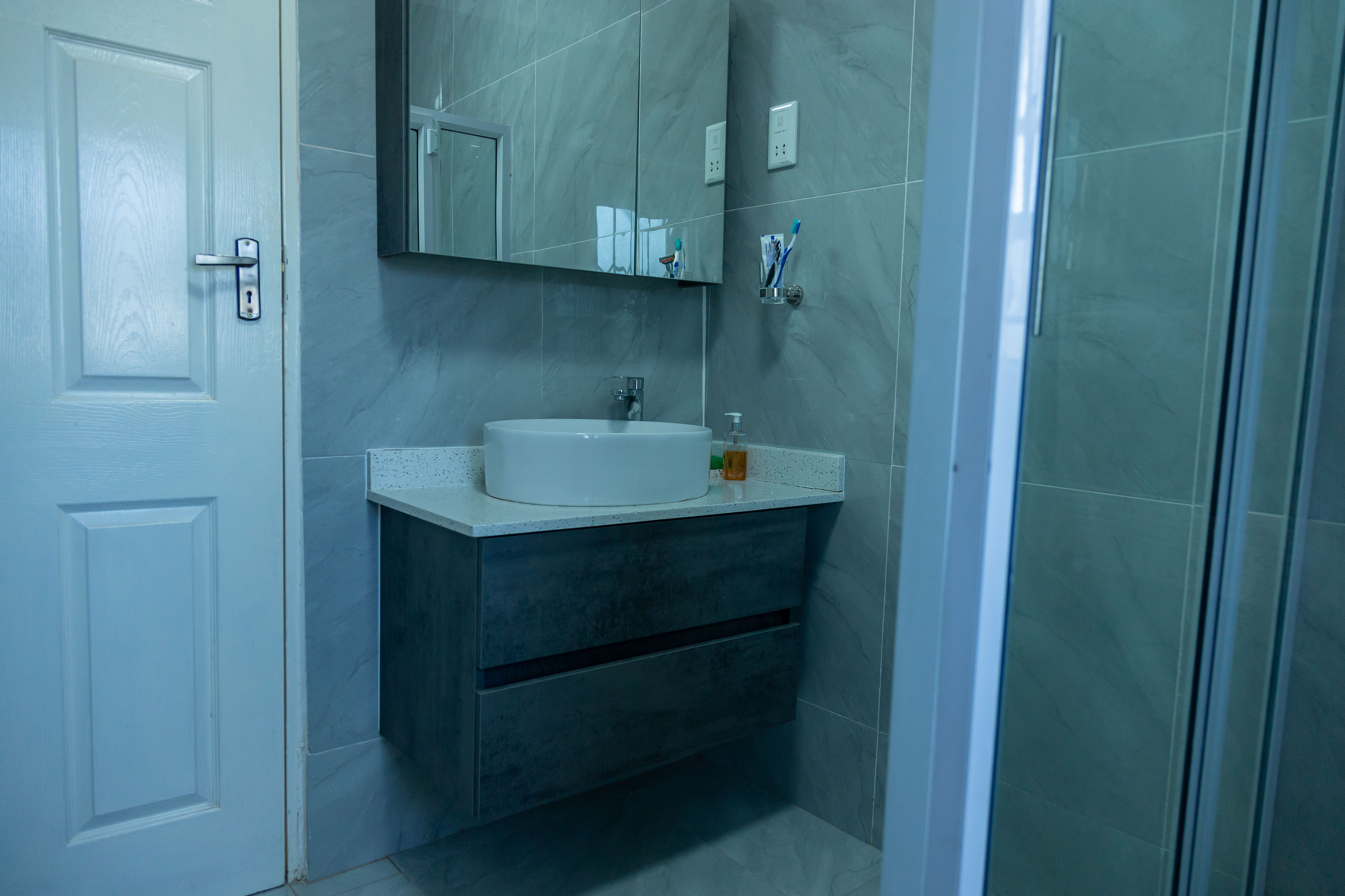 Bathroom vanity with a vessel sink and mirror cabinet