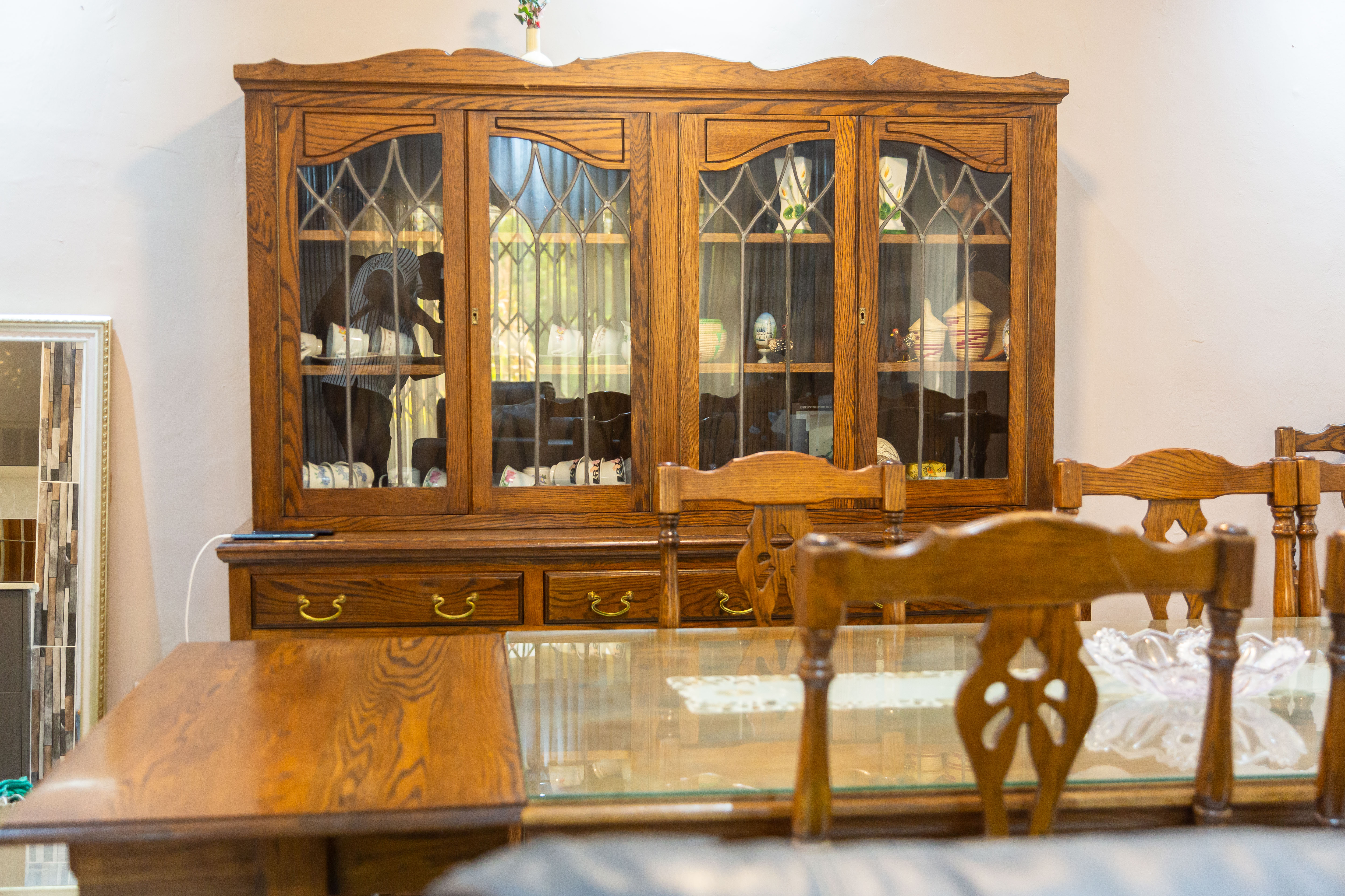 Wooden display cabinet filled with glassware in the dining room